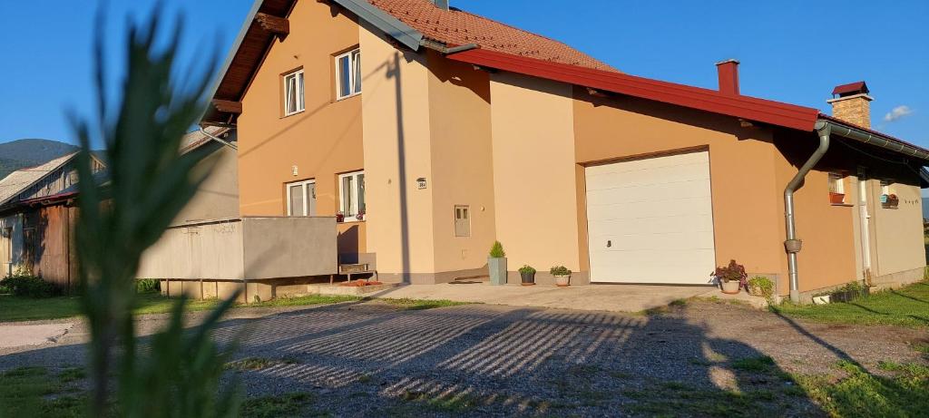 a house with a garage with a red roof at Rooms Marina in Korenica
