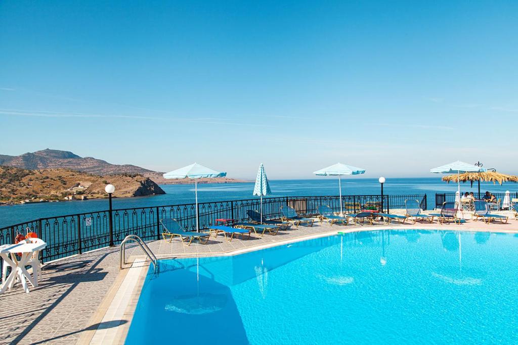 a swimming pool with a view of the ocean at Anaxos Hill in Anaxos