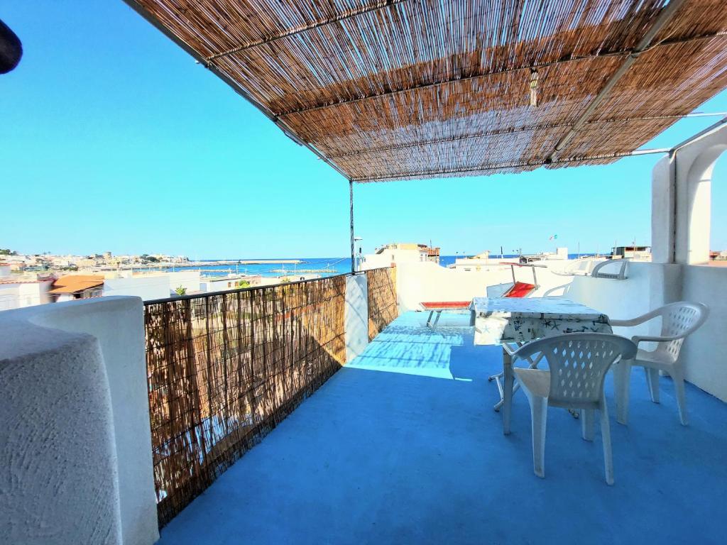 a balcony with a table and chairs and the ocean at Appartamenti Iacono in Forio d'Ischia