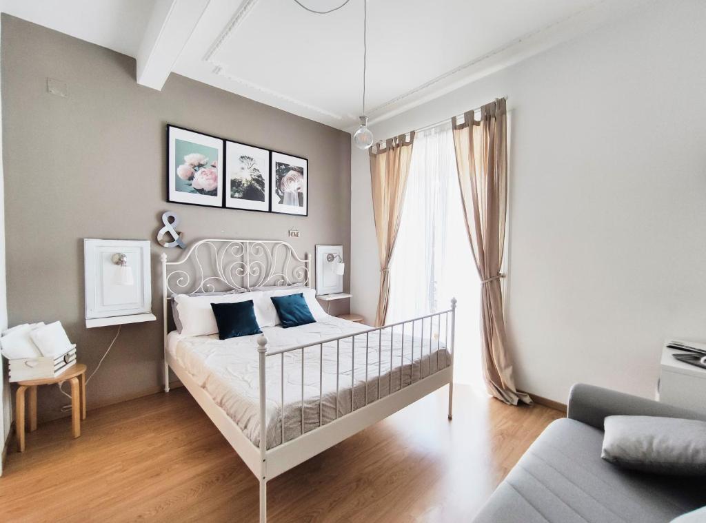 a bedroom with a white bed with blue pillows at TuttoTondo Roma in Rome