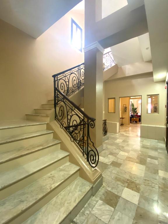 a staircase with a wrought iron railings and a tile floor at Magnolia Inn in Panama City