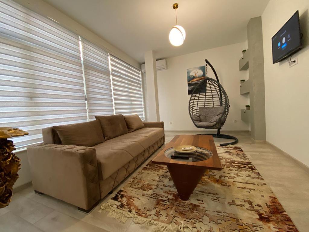 a living room with a couch and a coffee table at Koca Apartmani in Novi Pazar