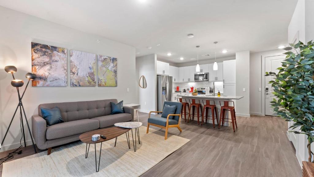 ein Wohnzimmer mit einem Sofa und einer Küche in der Unterkunft Luxury Central Apts - Free Parking, Gym, Fast WiFi in Austin