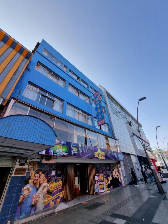 a blue building with advertisements on the side of it at HOTEL ASTORE Matta 2537 in Antofagasta