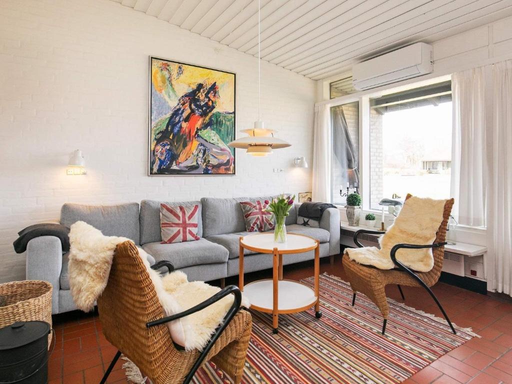 a living room with a couch and a table at 6 person holiday home on a holiday park in Sæby in Sæby