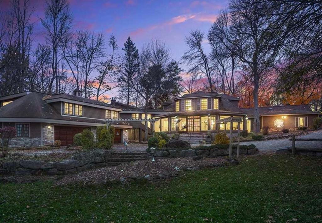 a large house with many windows at night at heritage style cottage by the lake in Orillia