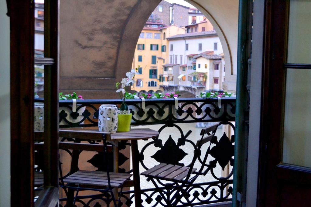 a balcony with a table and chairs on a balcony at Pontevecchio Relais in Florence