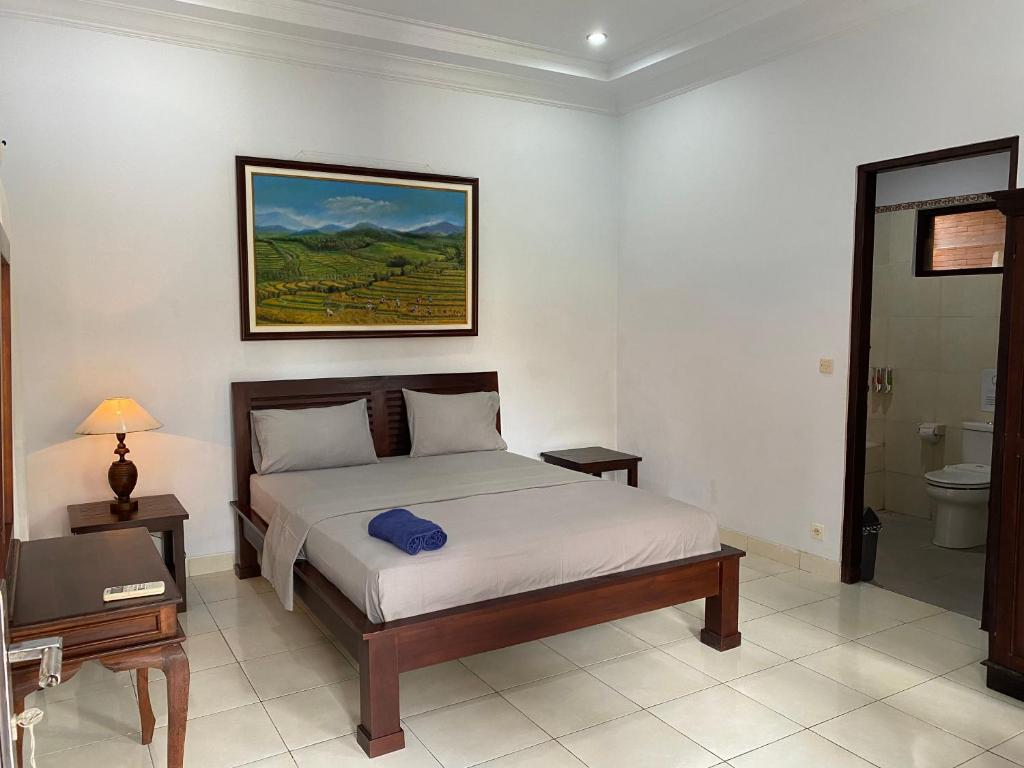 Postel nebo postele na pokoji v ubytování Santana Bali Home stay
