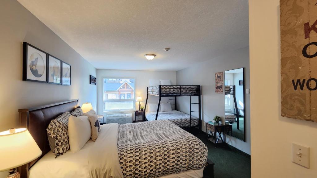 a bedroom with a large bed and a room with a bedroom at Mountain View Inn in Canmore