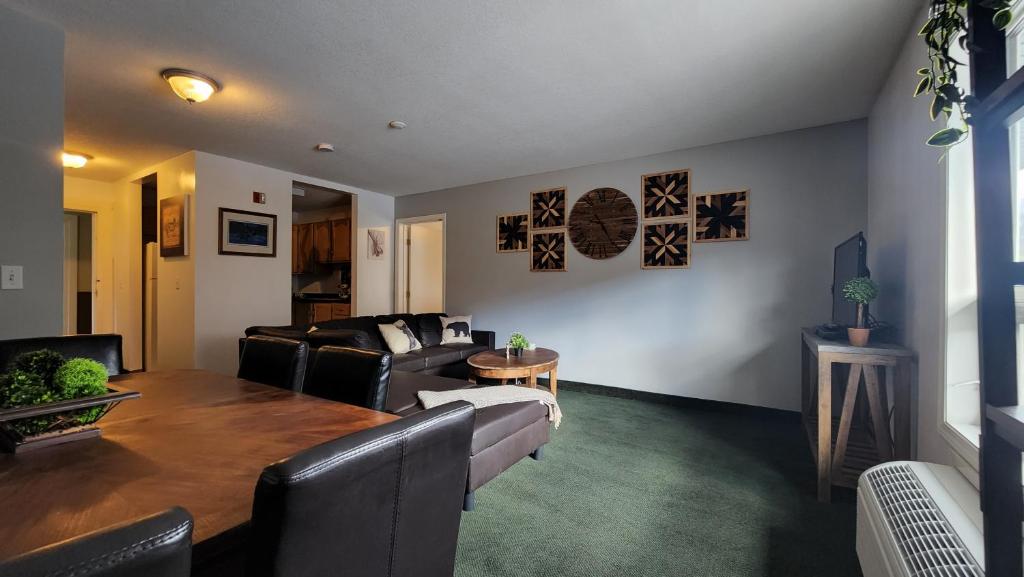 a living room with a couch and a table at Mountain View Inn in Canmore