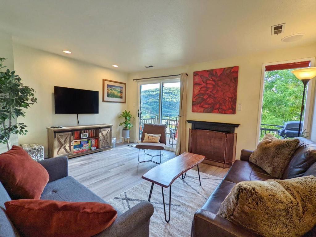 a living room with two couches and a tv at Old Town Views Just Steps to Main Street and Mountains for Skiing, Hiking, Biking in Park City