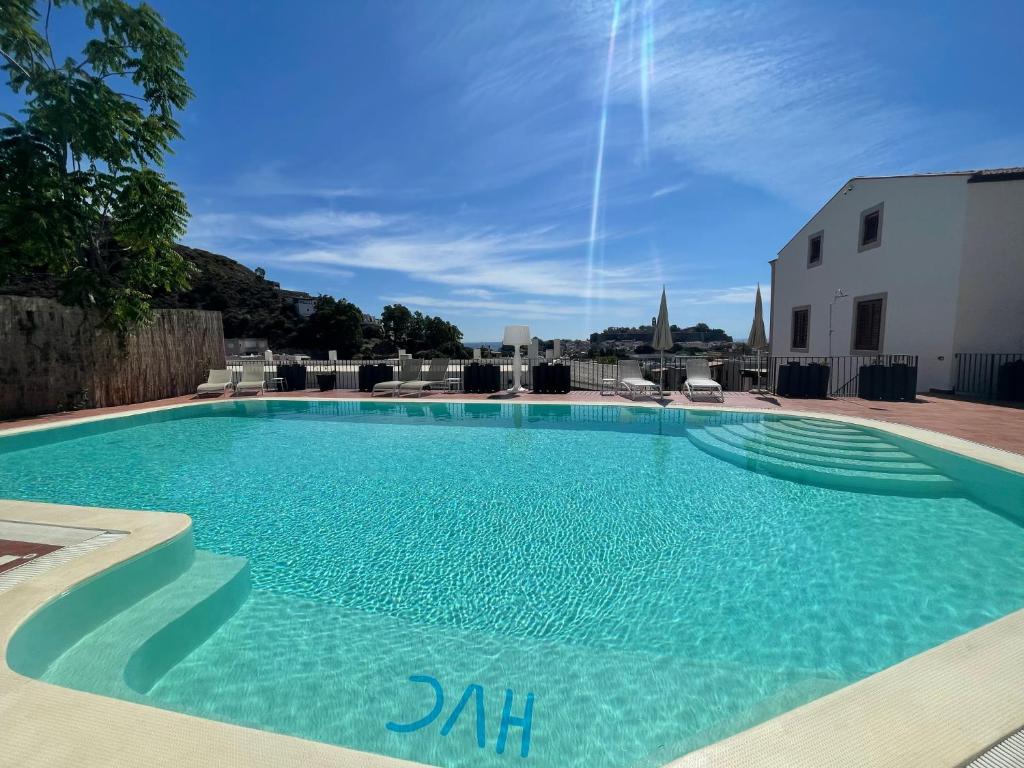 a large swimming pool with blue water at Hotel Villa Cute - HVC in Lipari