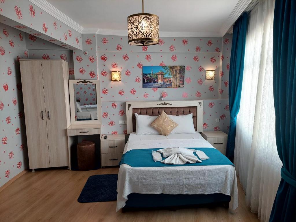 a bedroom with a bed and a chandelier at Galaxy Hotel Sultanahmet in Istanbul