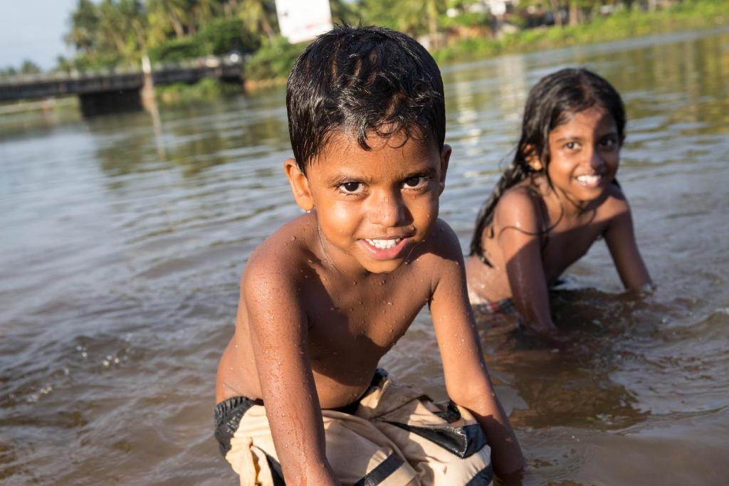 two children are in the water in the water at Arabella on Boossa in Galle