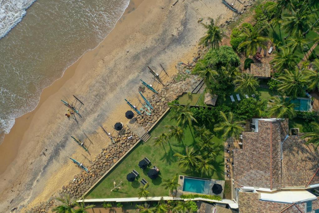 an aerial view of a beach with palm trees at Arabella on Boossa in Galle