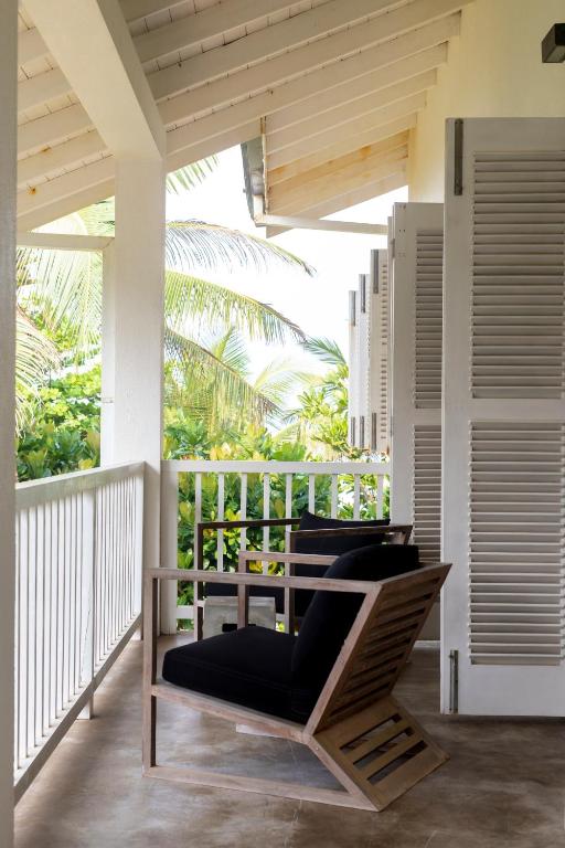 a porch with chairs on a balcony at Arabella on Boossa in Galle