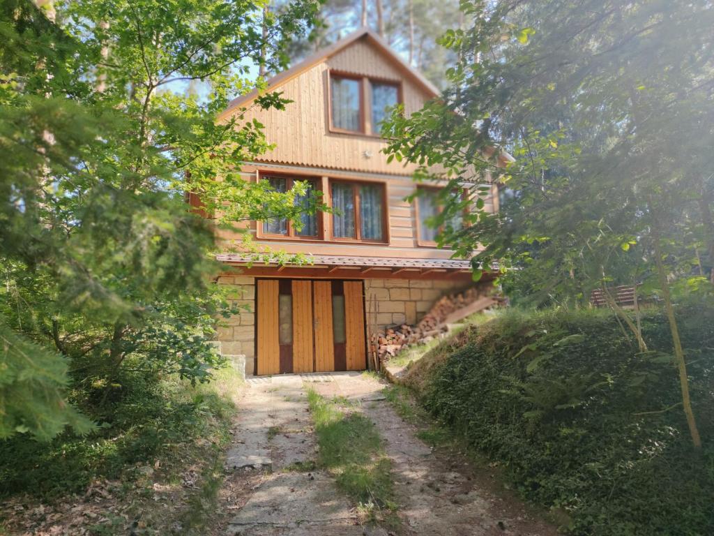 a house in the middle of a dirt road at Chata Doksy, Bílý Kámen 337 in Doksy