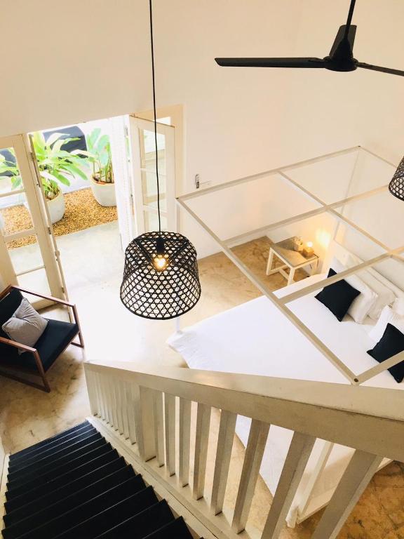 a living room with a table and a chandelier at Arabella on Boossa in Galle