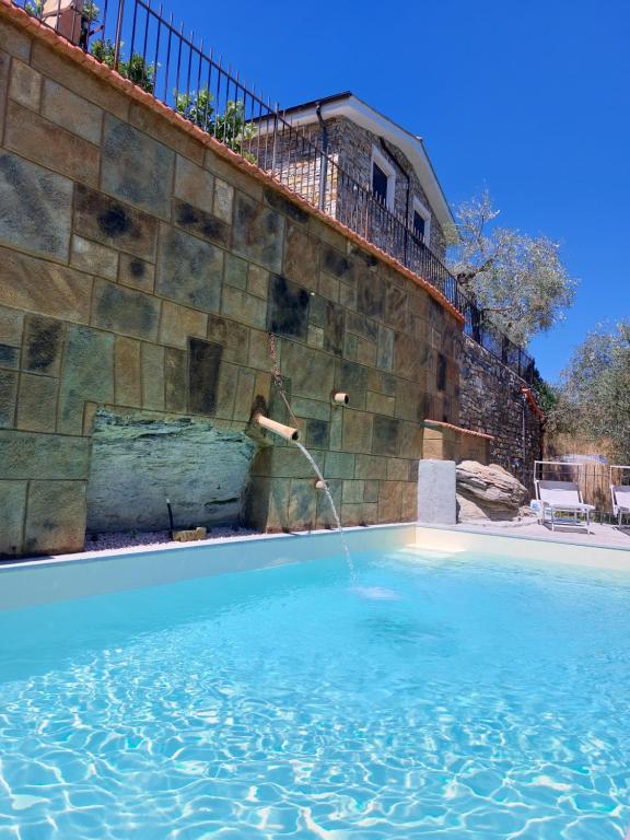 a water fountain in a swimming pool at Villa Desideri Agriturismo Dinoabbo in Lucinasco