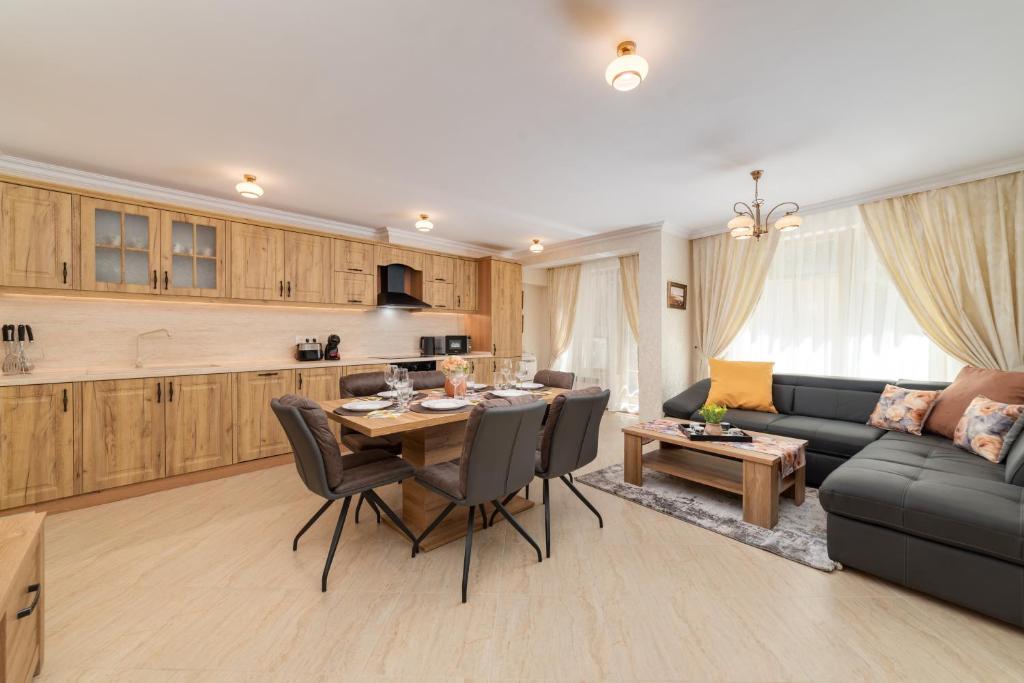 Il comprend une cuisine et un salon avec une table et un canapé. dans l'établissement Deluxe and Central Garden Apartment, à Varna