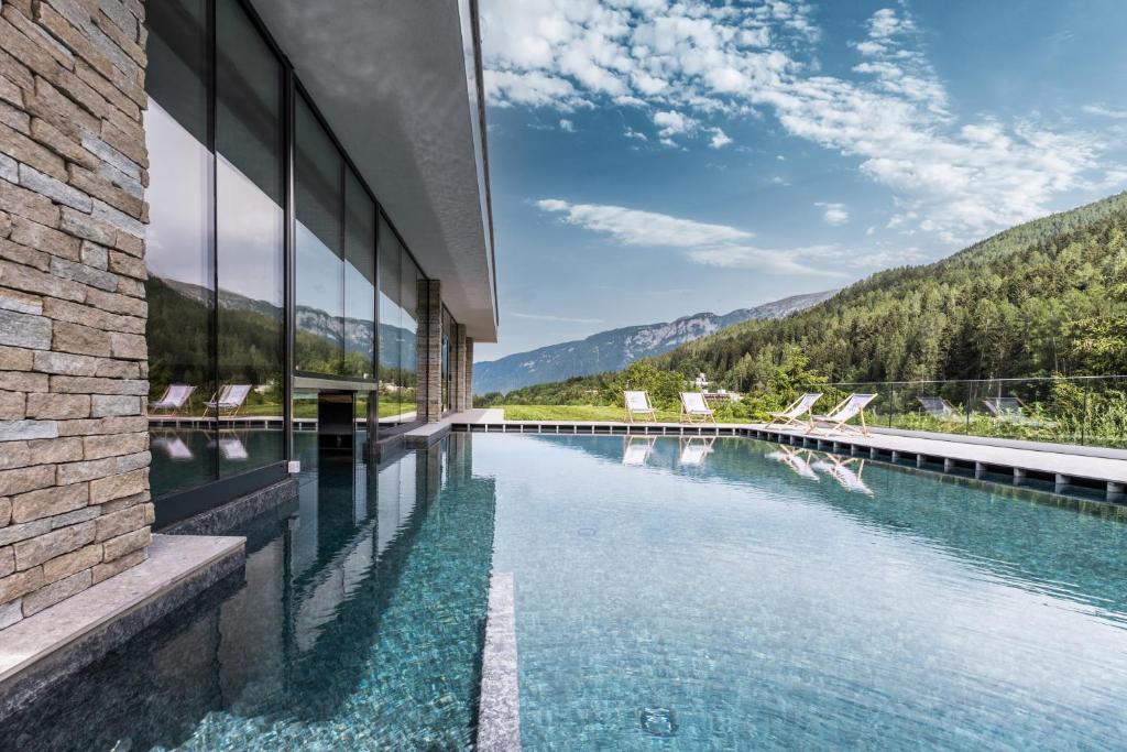 uma piscina com vista para uma montanha em Gaia Residence Hotel em Mezzana