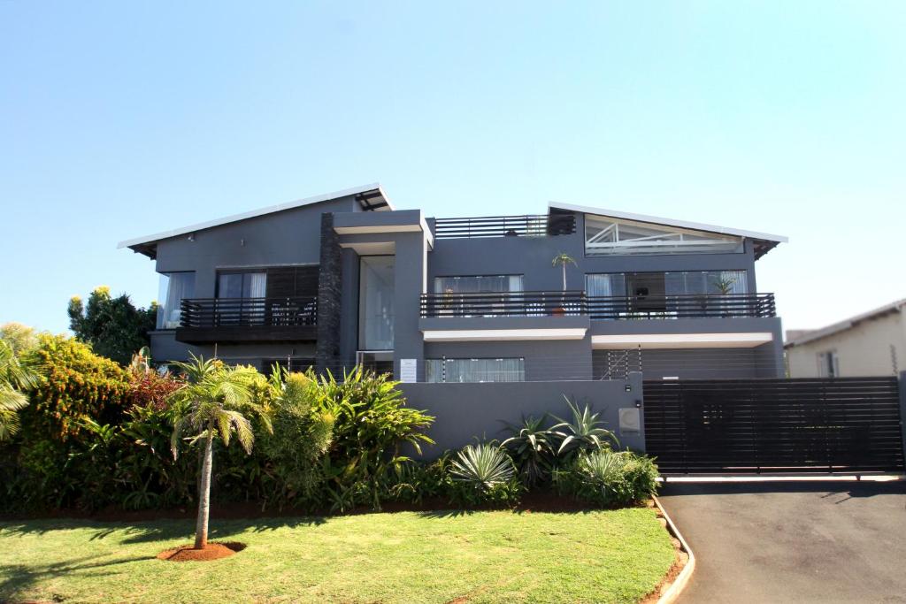 a large house with a garden in front of it at Sea Dreams Guesthouse in Ballito