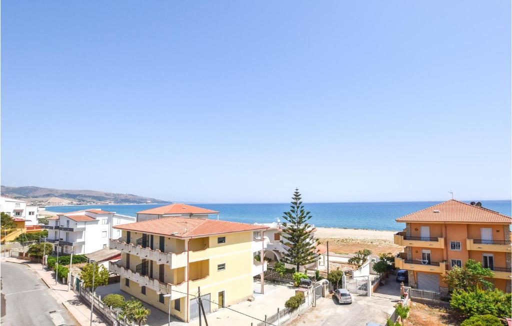 a view of a street with houses and the ocean at Awesome Apartment In Marina Di Strongoli With Wifi in Marina di Strongoli