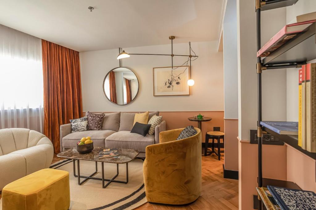 a living room with a couch and a table at Backstage Hotel - an Atlas Boutique Hotel in Tel Aviv