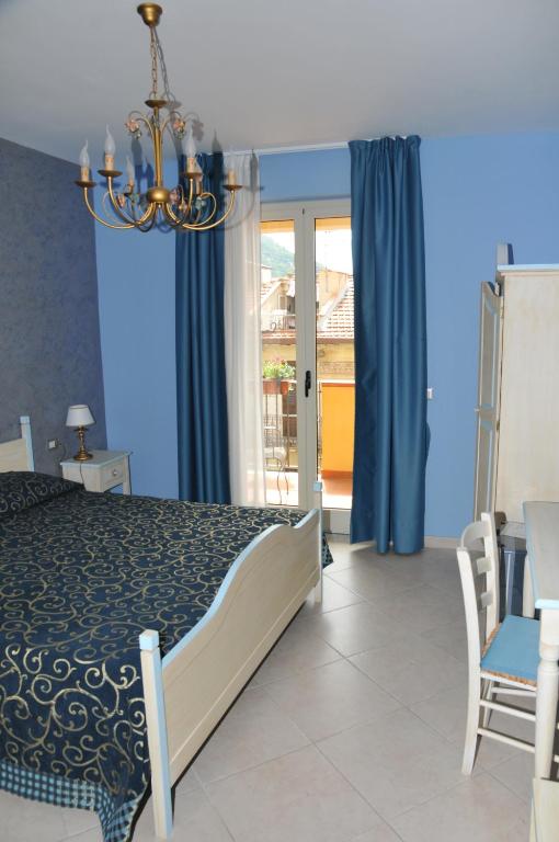 a bedroom with a bed and a chandelier at Hotel Scilla in Scilla