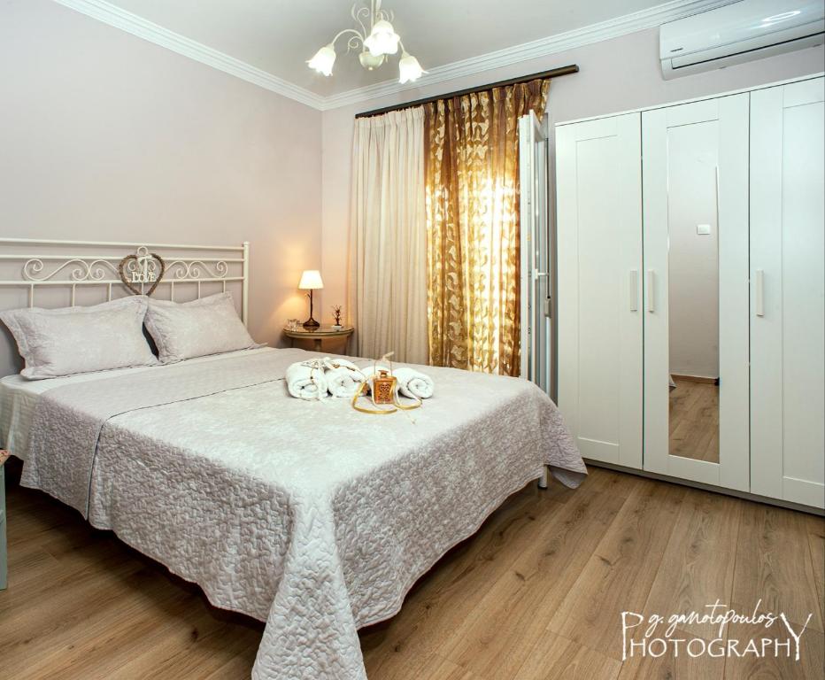 a bedroom with a bed with a white bedspread at Mary's Dreamy Maisonette in Volos