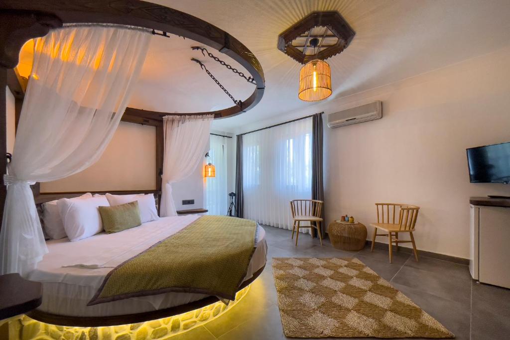 a bedroom with a large bed with a canopy at Limon Apart in Akyaka