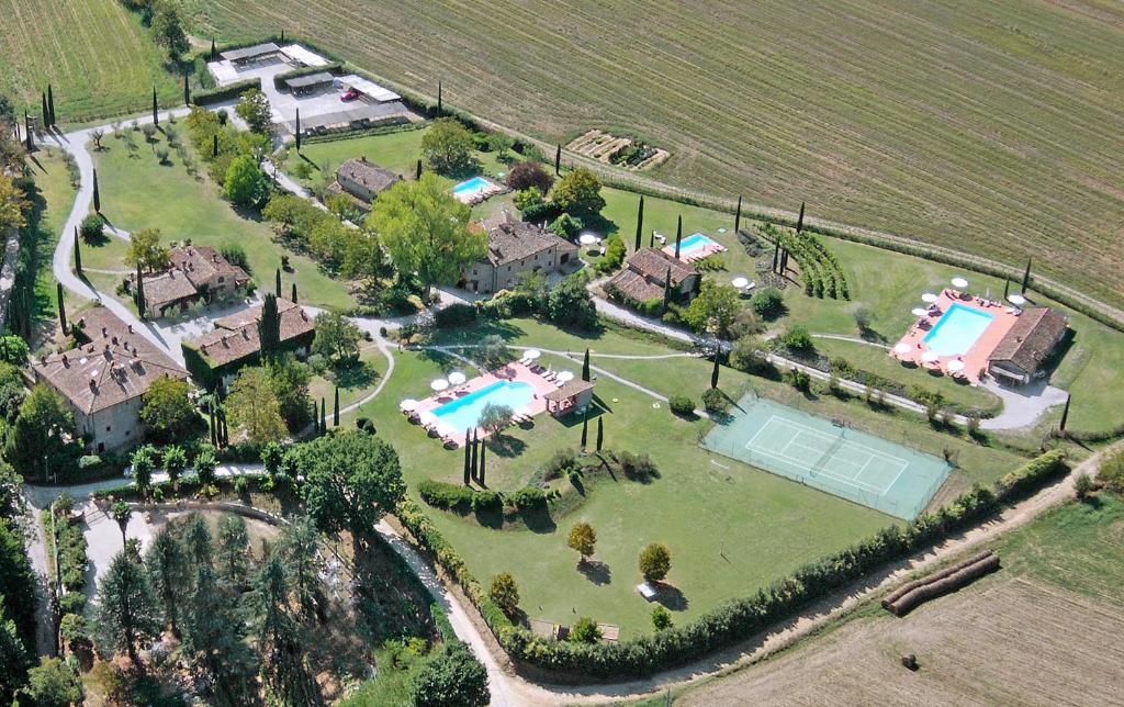 an aerial view of a house with a tennis court and a pool at Monsignor Della Casa Country Resort & Spa in Borgo San Lorenzo