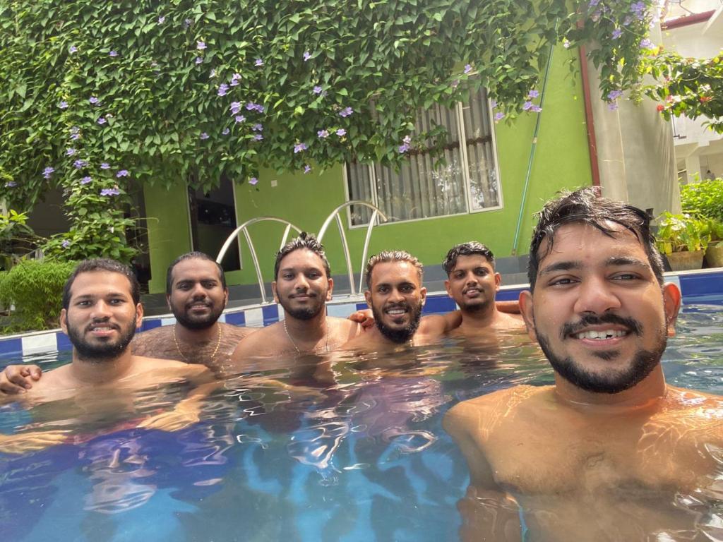 a group of men in a swimming pool at Abha Villa in Galle