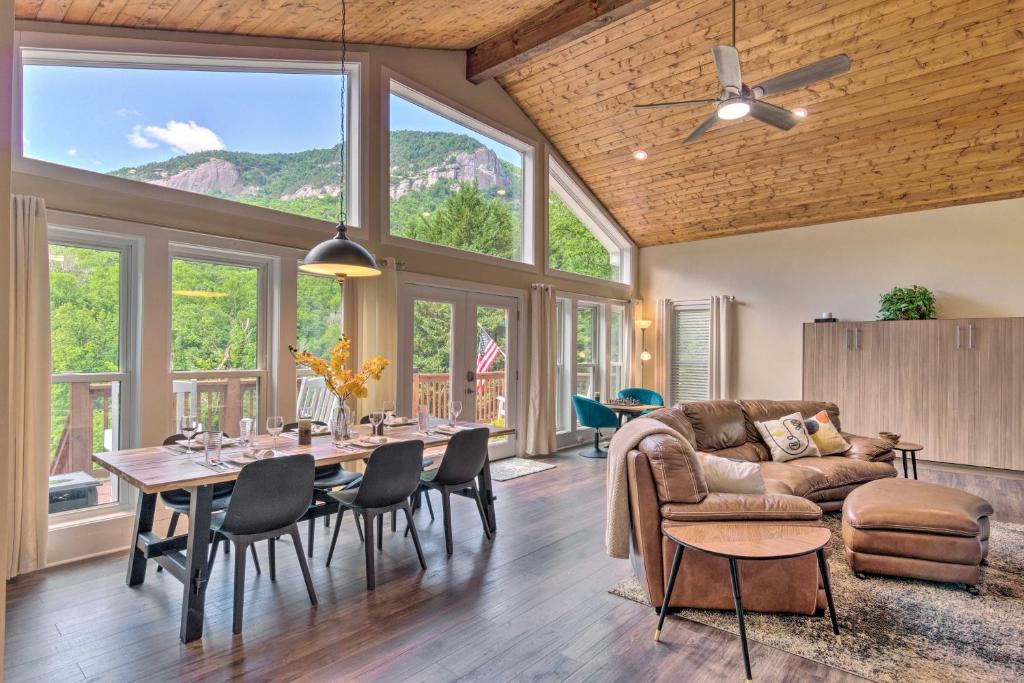 a living room with a table and a couch at Unique Chimney Rock Home with Breathtaking View in Lake Lure