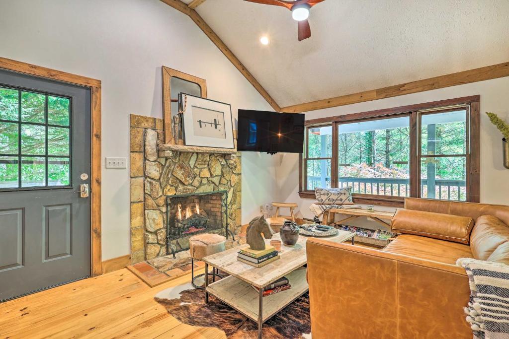 a living room with a couch and a fireplace at Boone Hideaway with Deck, Grill and Forest Views! in Boone