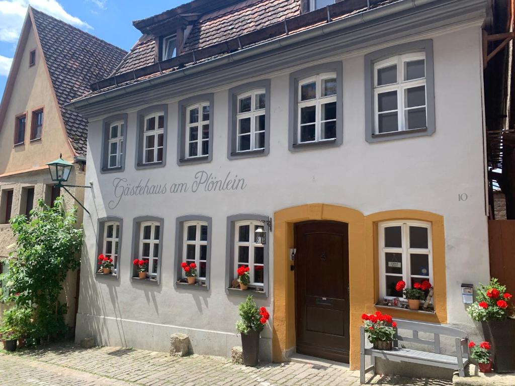 a white building with a sign on the side of it at Gästehaus am Plönlein in Rothenburg ob der Tauber