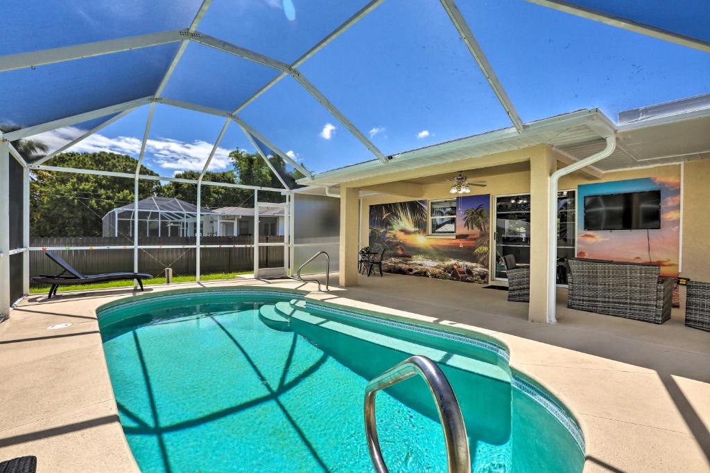 a swimming pool in the middle of a house at Charming N Fort Meyers Retreat Pool and Lanai! in North Fort Myers