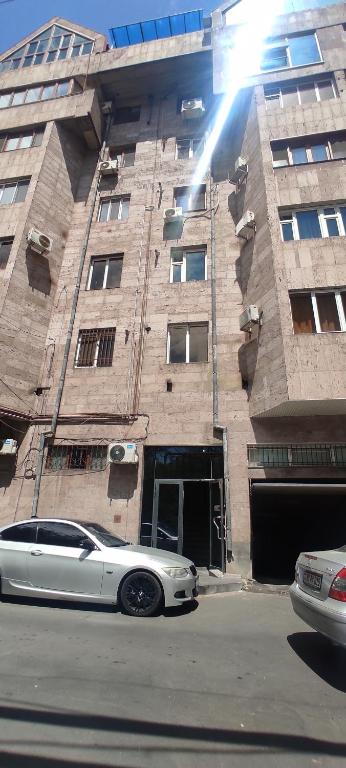 a white car parked in front of a building at Roma Apartament in Yerevan