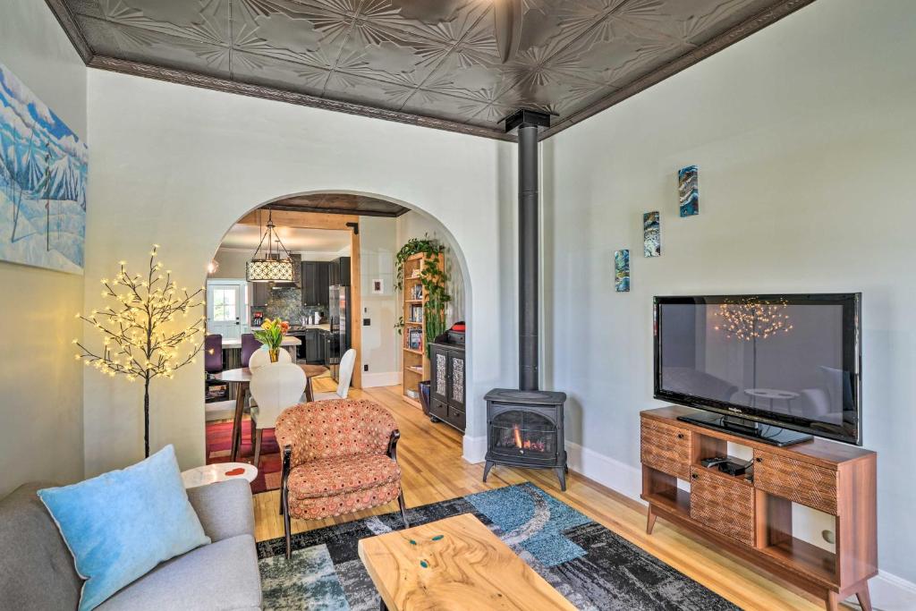 a living room with a fireplace and a tv at Pet-Friendly Home with Patio in Downtown Salida in Salida