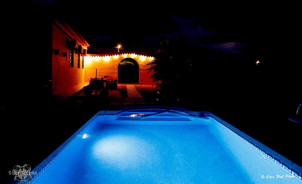 a swimming pool in a yard at night at Villa Soluna in Cantoria