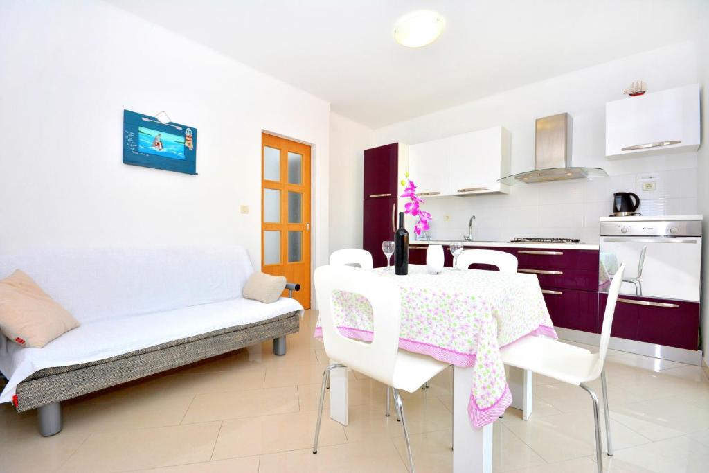 a kitchen and dining room with a table and chairs at Apartments Dida in Hvar