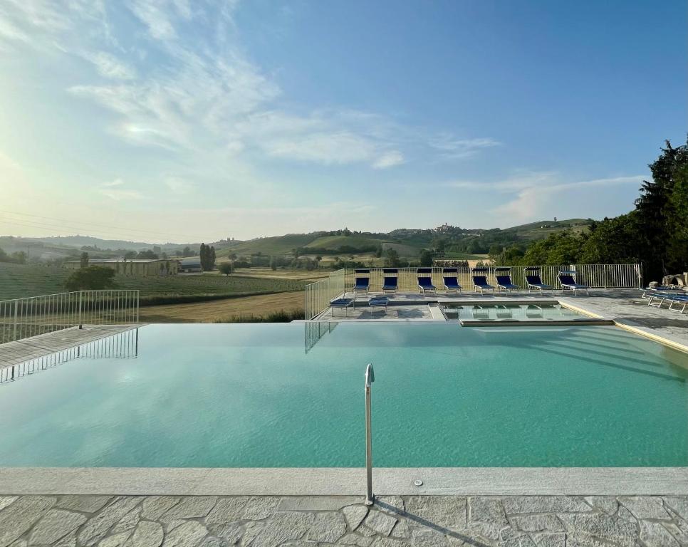 a swimming pool with a view of the hills at Agriturismo La Mussia in Castelnuovo