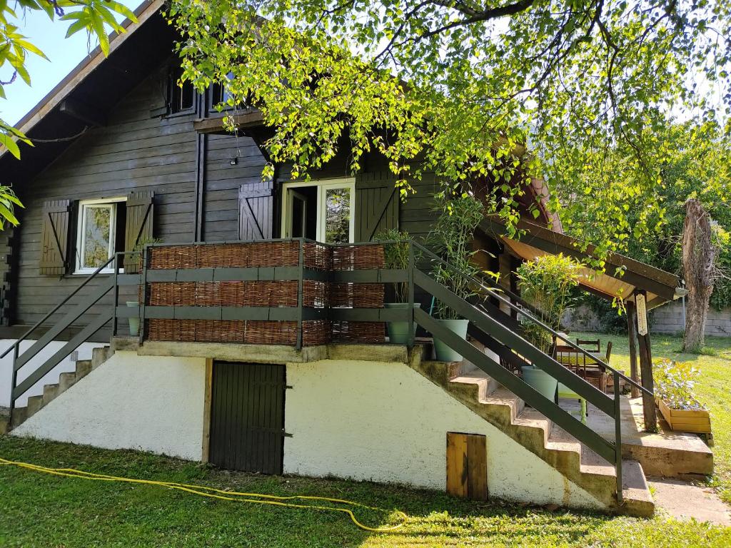 a house with stairs leading up to a house at Le Chalet de Goncelin in Goncelin