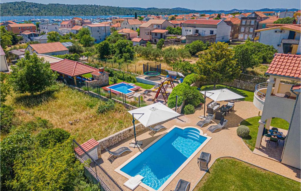 an overhead view of a swimming pool with umbrellas at Stunning Home In Pirovac With Kitchen in Pirovac