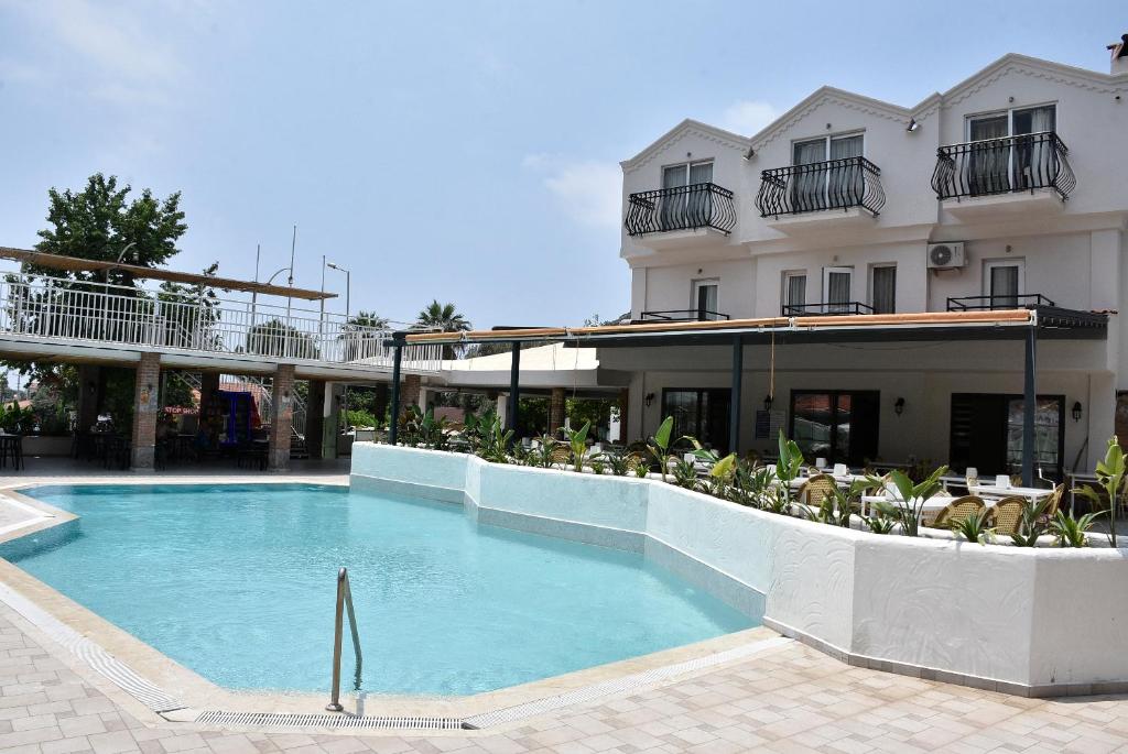 a swimming pool in front of a hotel at Magic Tulip Hotel in Oludeniz