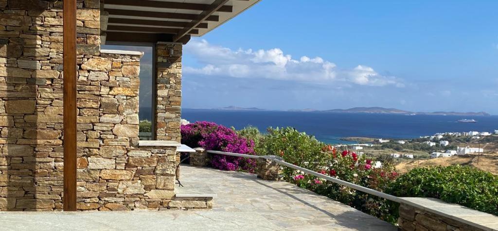a stone building with a view of the ocean at Oikia Petra in Agios Ioannis