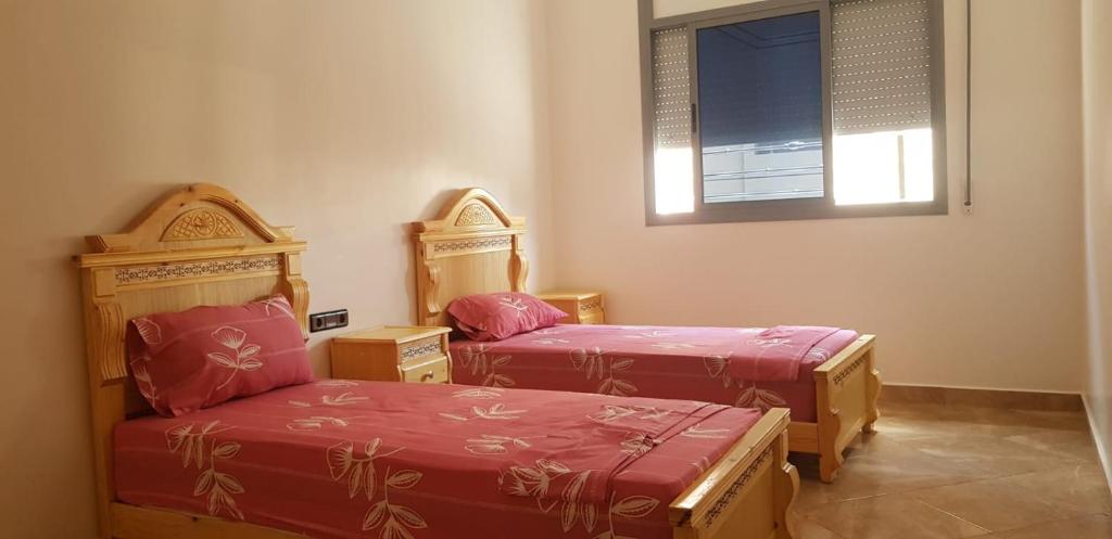 a room with two twin beds and a window at appartement boukidan in Al Hoceïma