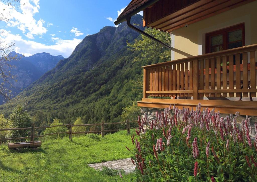 a house with a balcony with a view of mountains at Zadnjica Holiday House in Soča