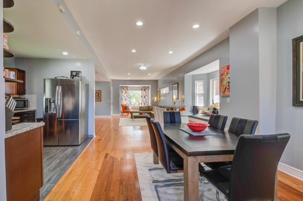 a kitchen and dining room with a table and chairs at Spacious 5-BR House near Transit w Parking in Chicago