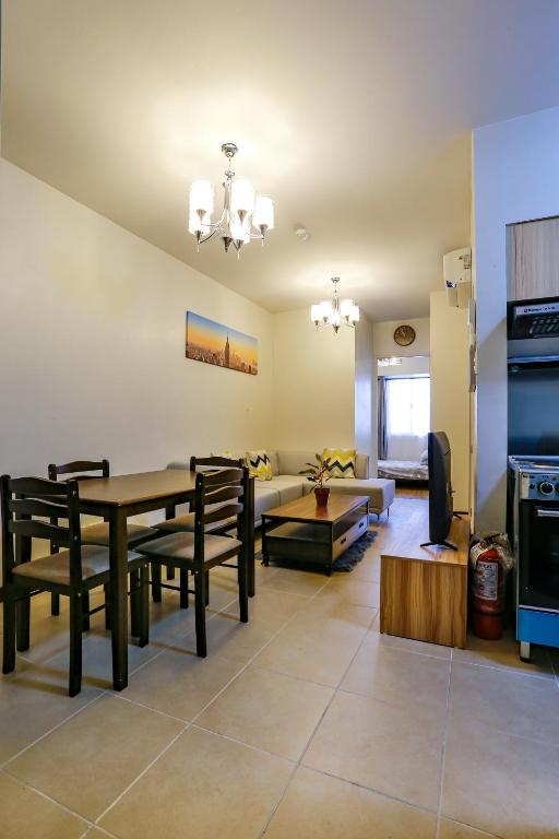 a living room with a table and a couch at Verdon Parc 2 bedroom apartment Ocean View in Davao City